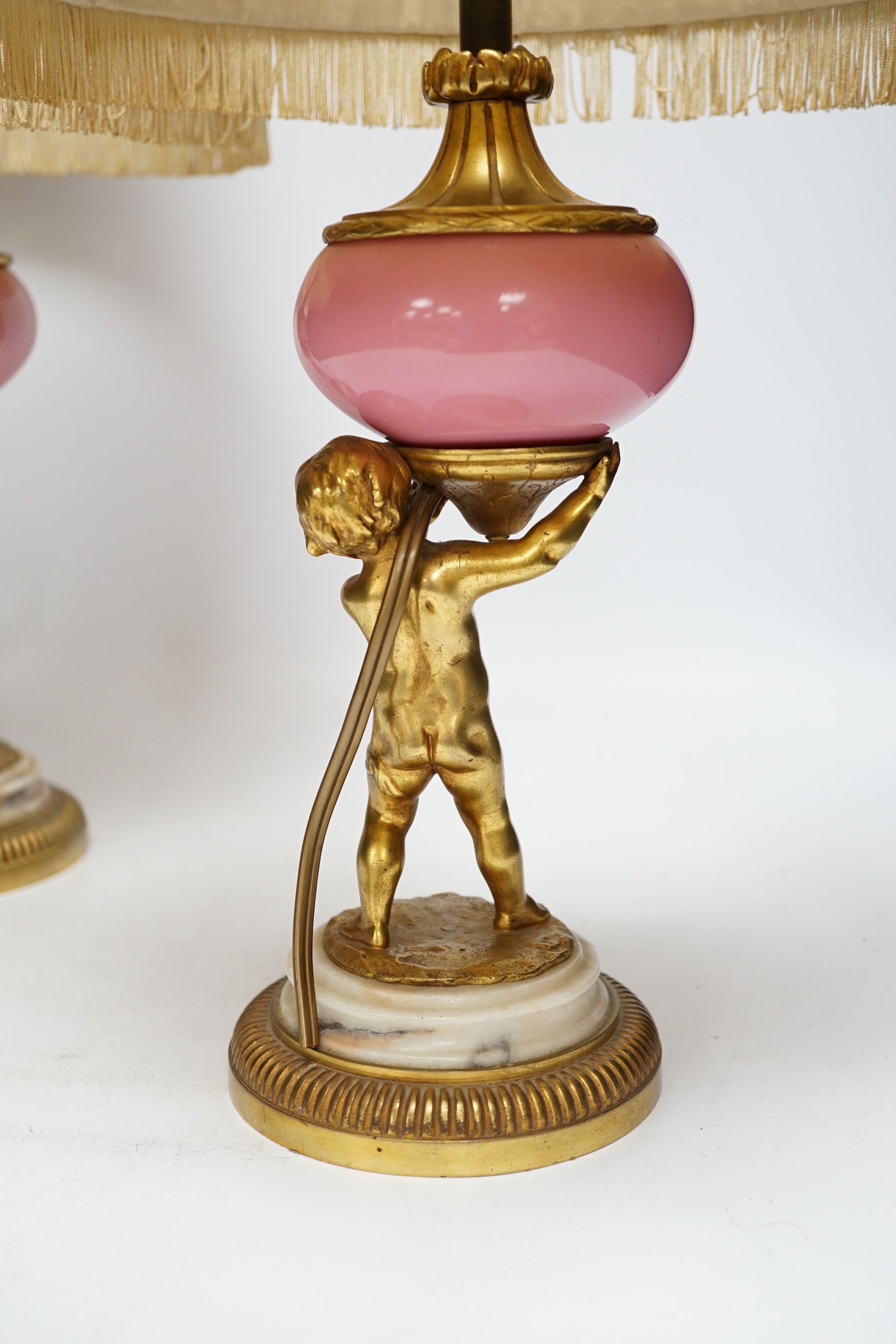 A pair of early 20th century French ormolu and porcelain cherubic lamps, one signed L. Kley, 48cm including shade